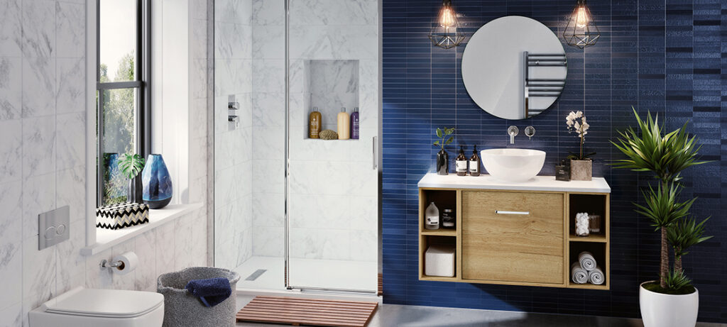 Modern bathroom with blue and white tiles, wooden vanity, round mirror, glass shower, potted plant, decorative vases, window view, and towel storage.