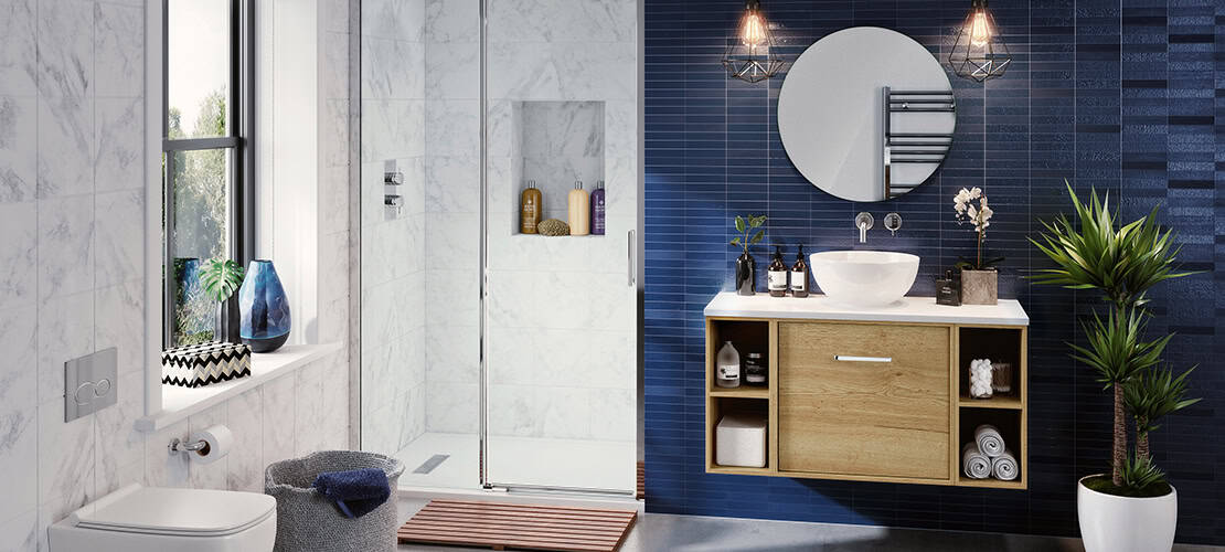 Modern bathroom with blue and white tiles, wooden vanity, round mirror, glass shower, potted plant, decorative vases, window view, and towel storage, designed by Kallums Bathrooms, Guildford and Putney.