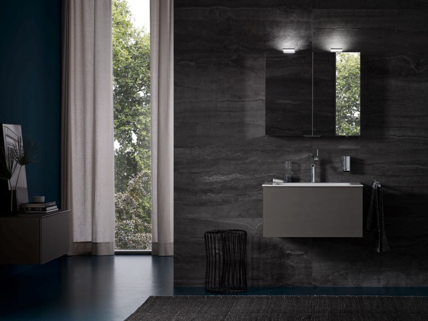 Modern bathroom interior with dark stone walls, floating vanity, round mirror, and large window with tree view. Minimalist decor features sleek finishes.