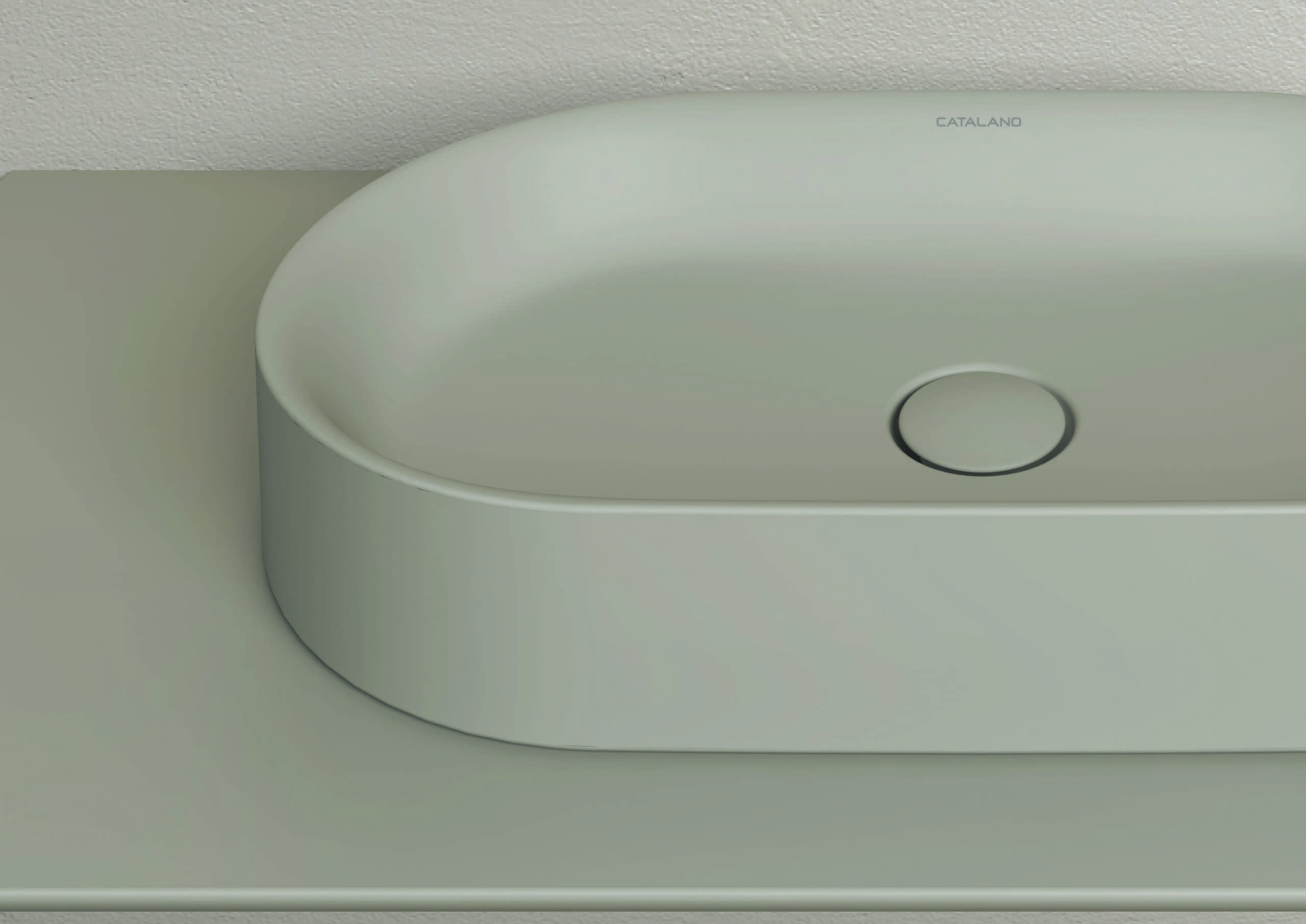 A sleek, minimalist sink with a smooth, rounded design, mounted on a light surface, displaying a modern and elegant aesthetic.
