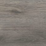 A textured wooden surface, featuring natural grain patterns in subtle shades of gray and brown, provides a rustic and elegant appearance.