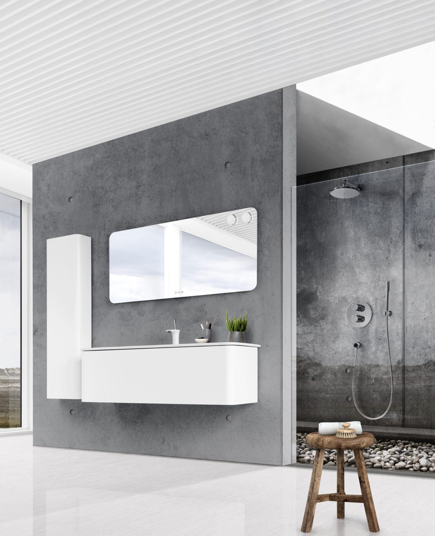 A modern bathroom features a sleek white vanity, large mirror, concrete walls, and pebble floor shower. A stool holds toiletries.