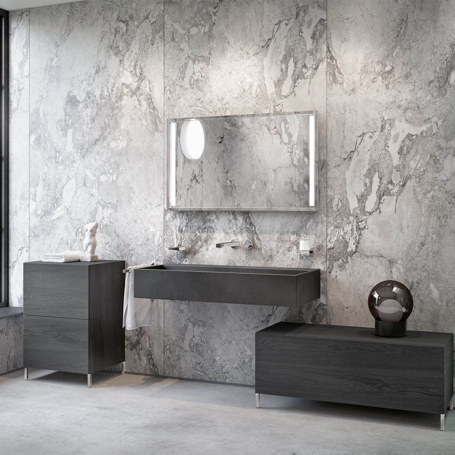 Modern bathroom with gray marble walls, sleek black vanity, large mirror, and minimalist decor, including a towel and spherical lamp on a cabinet.