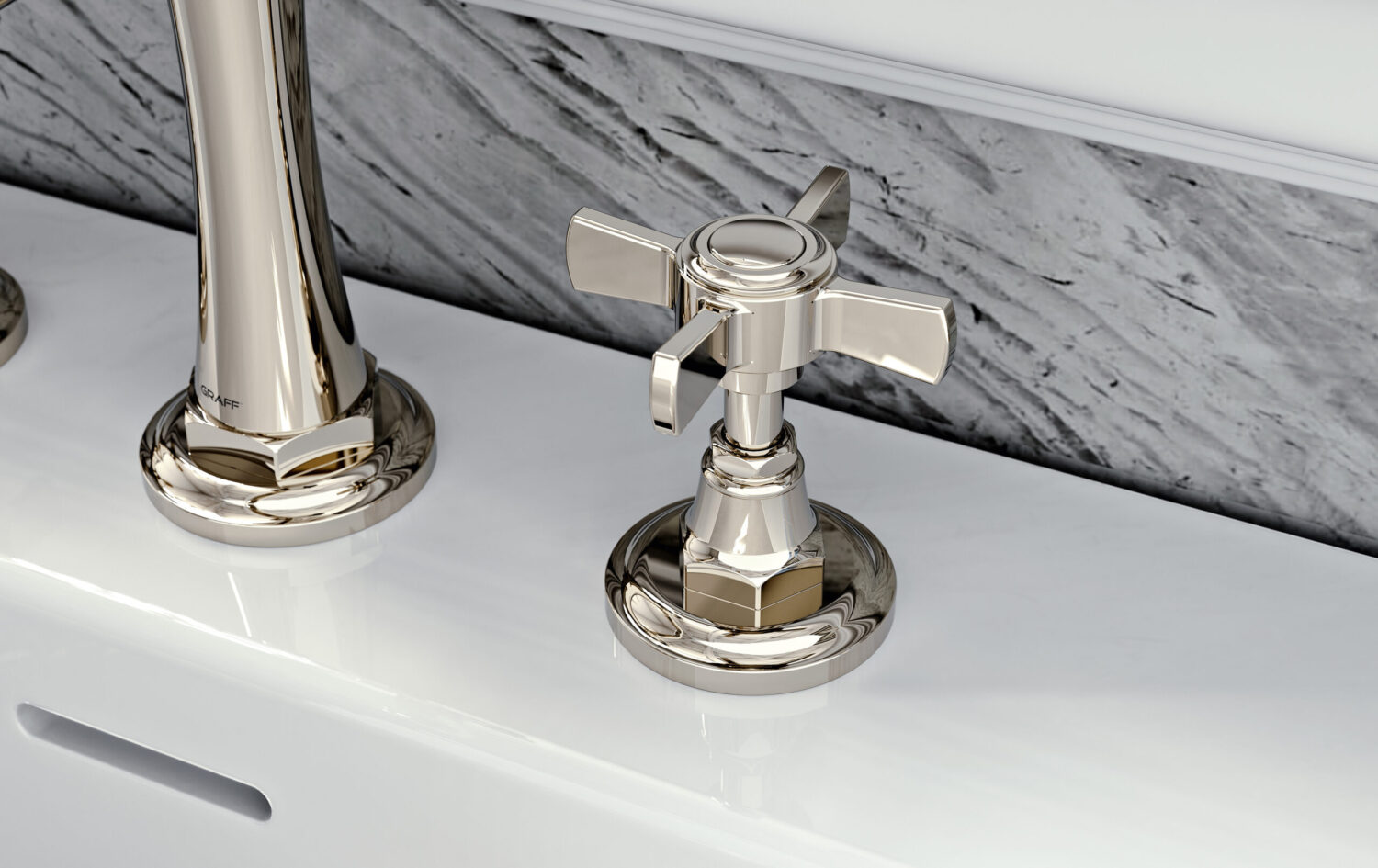 A modern, chrome bathroom faucet and handle on a white countertop with a marbled gray backsplash, reflecting a sleek, minimalist design.