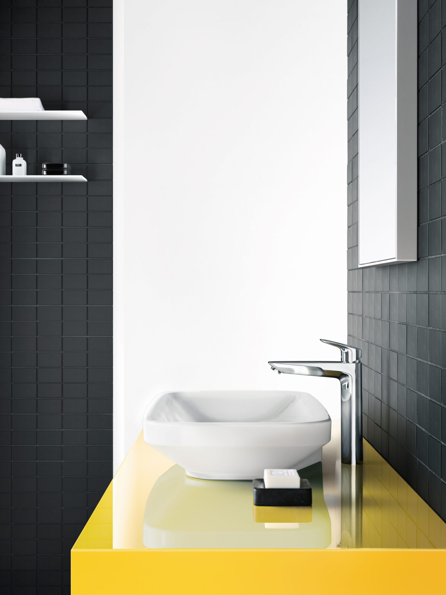 Modern bathroom with white sink on yellow counter, black tiled wall, wall-mounted shelf holding toiletries, and sleek chrome faucet. Minimalist, clean design.