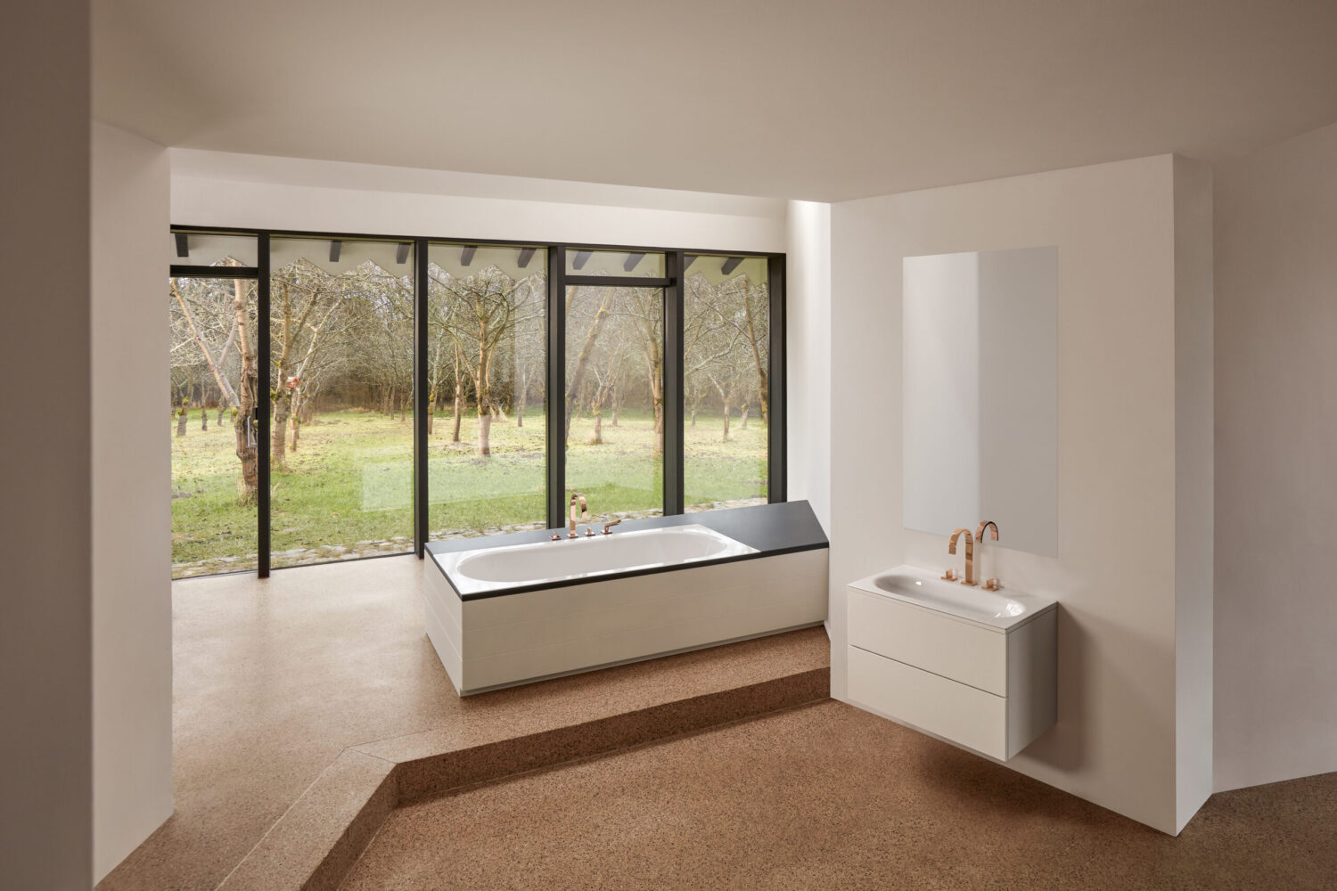 Modern bathroom with large windows overlooks a serene garden. Features a bathtub and sink, minimalist design, neutral tones, and abundant natural light.