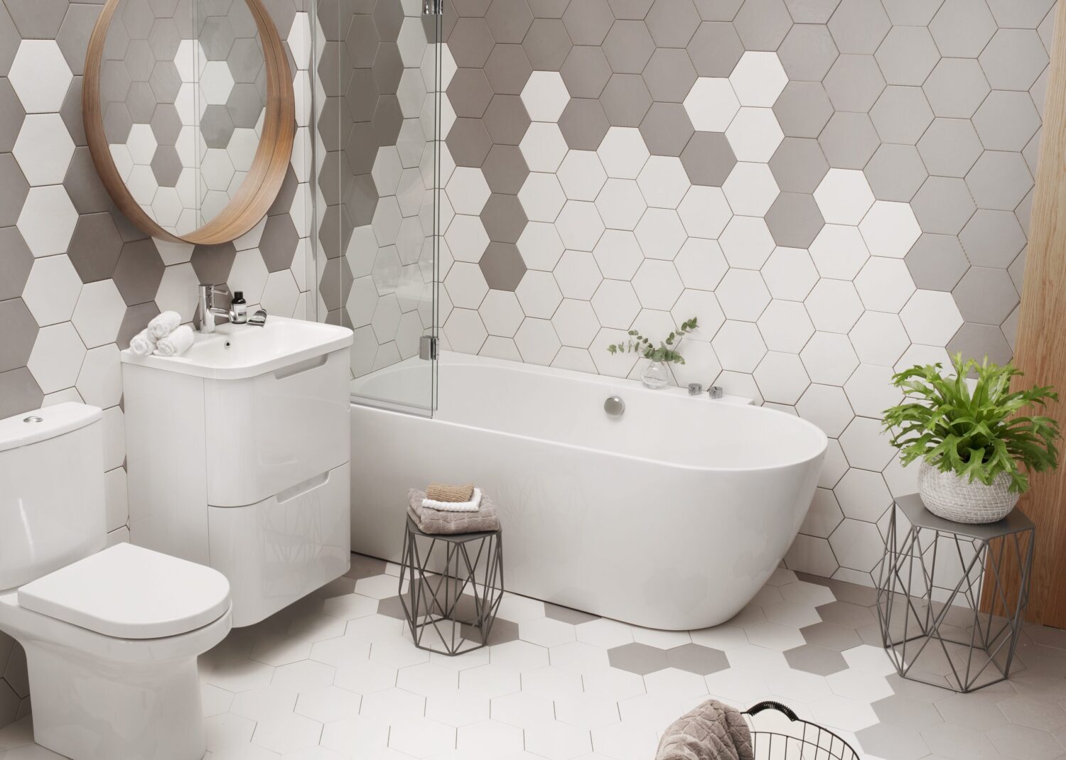 Modern bathroom with hexagonal tiles, round mirror, white fixtures, and potted plant on a side table, creating a clean, stylish aesthetic.