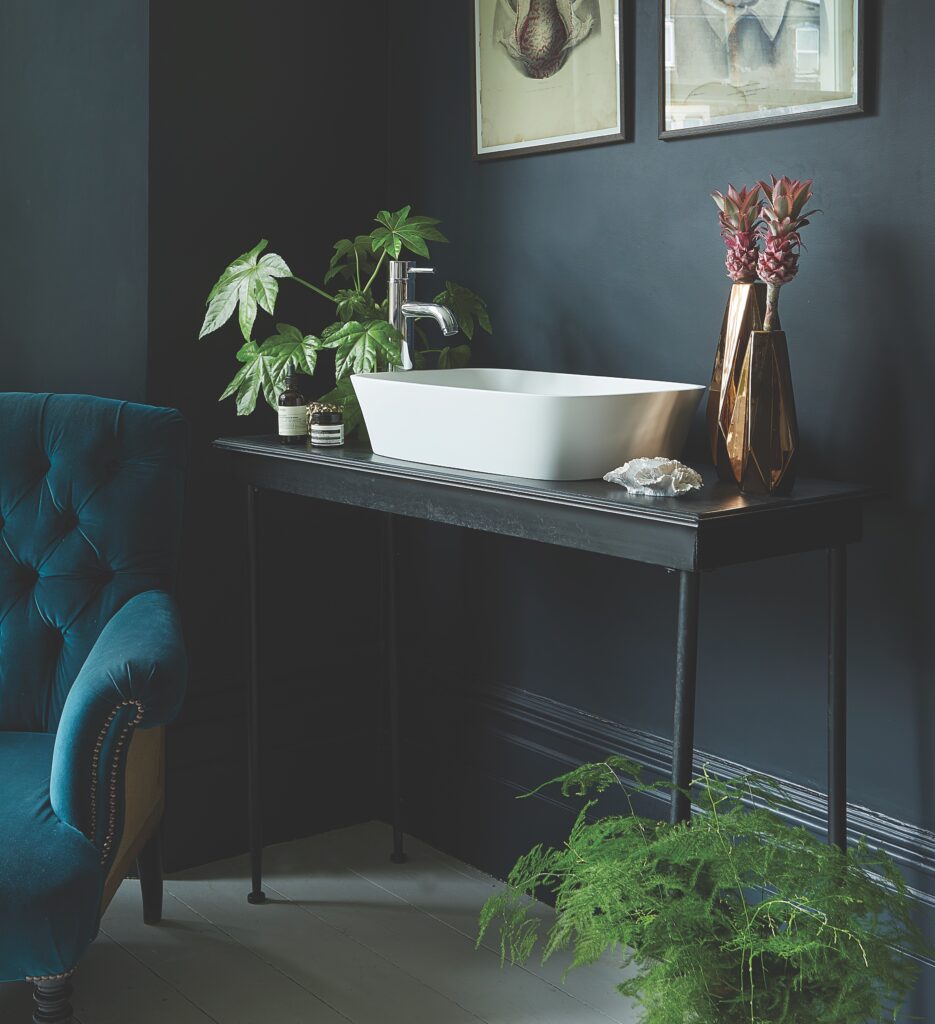 White square counter top basin with green plants nearby