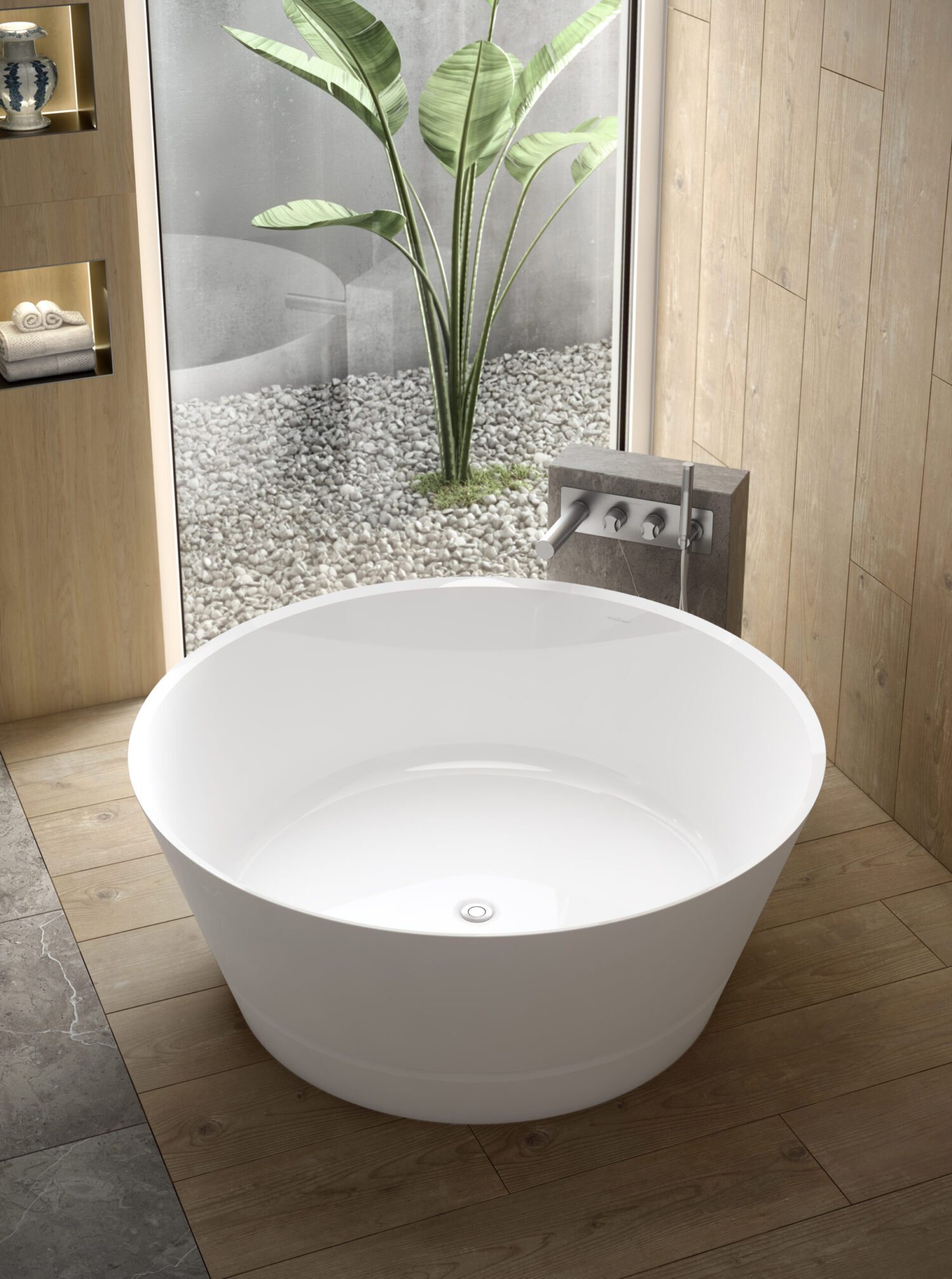 Modern bathroom with a round white bathtub, wooden floor, and a window view of a small garden with a large potted plant.