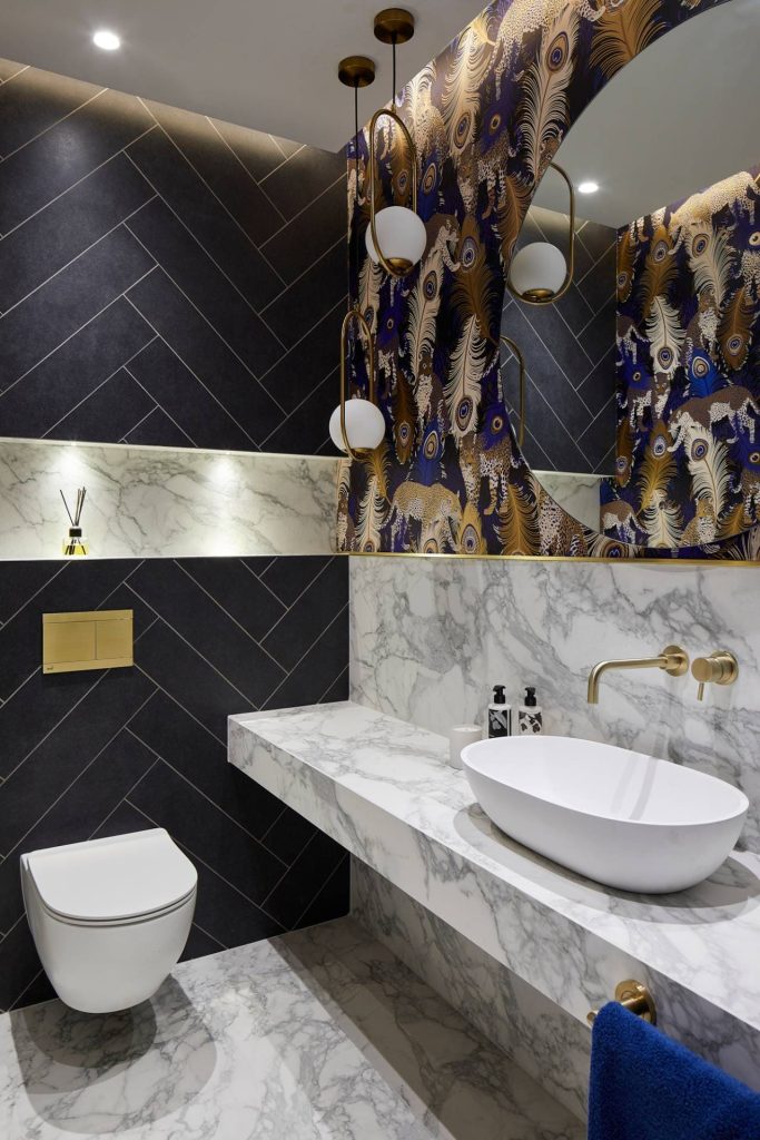 Luxury blue and white marble cloakroom with bold wallpaper