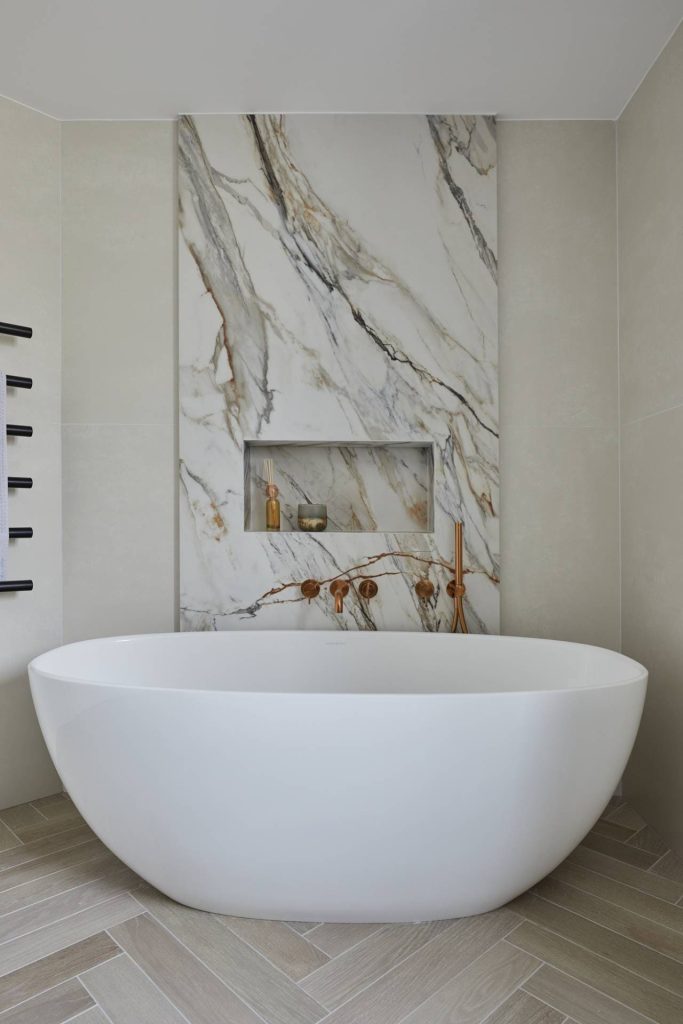 large freestanding bath in modern white marble bathroom