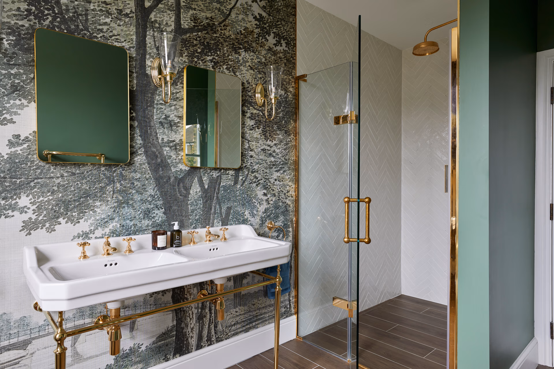 A chic bathroom showcasing a green wall paired with sophisticated gold fixtures, offering a fresh and elegant look.