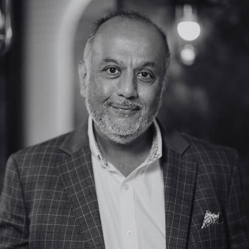 Professional portrait of a middle-aged man in a suit, black and white image.
