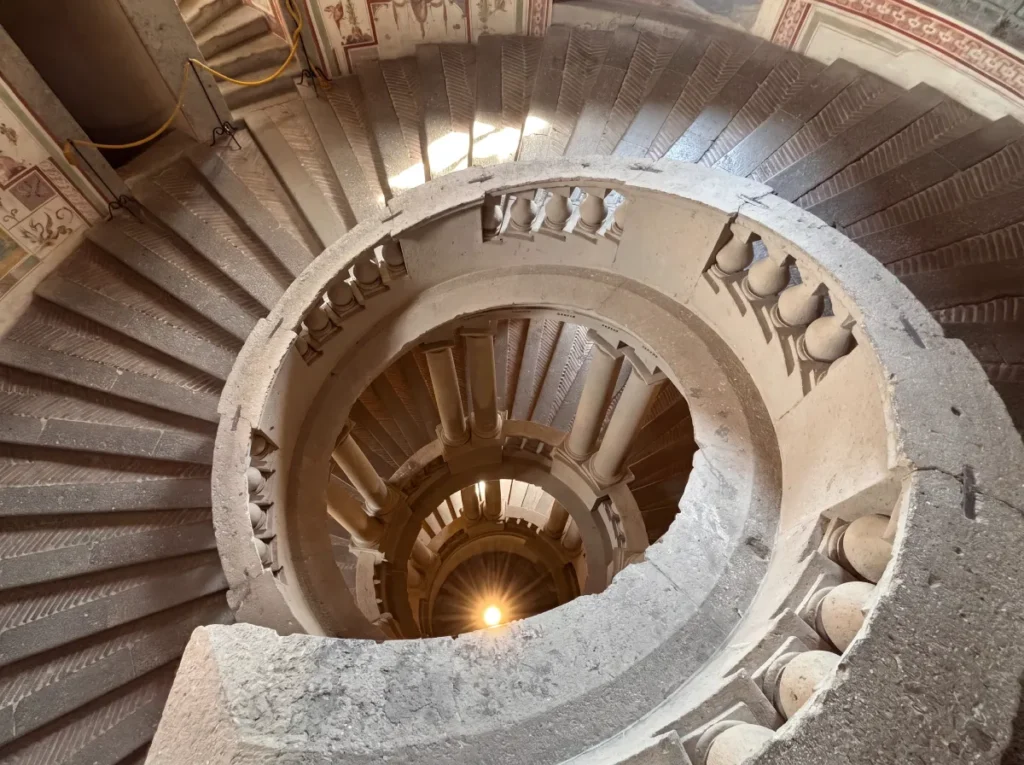 Spiral staircase looking down through Palazzo Farnese in Italy, visited by Kallums Bathrooms