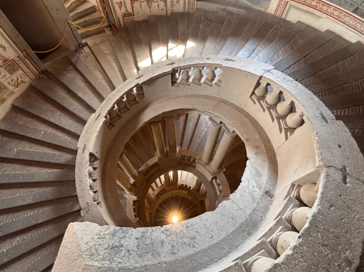 Spiral staircase looking down through Palazzo Farnese in Italy, visited by Kallums Bathrooms