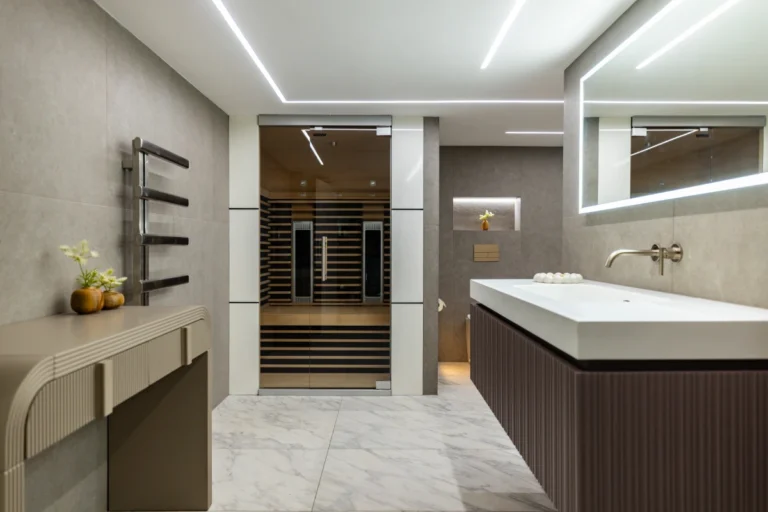 Modern guest bathroom with walk-in shower, sleek vanity, and contemporary lighting.