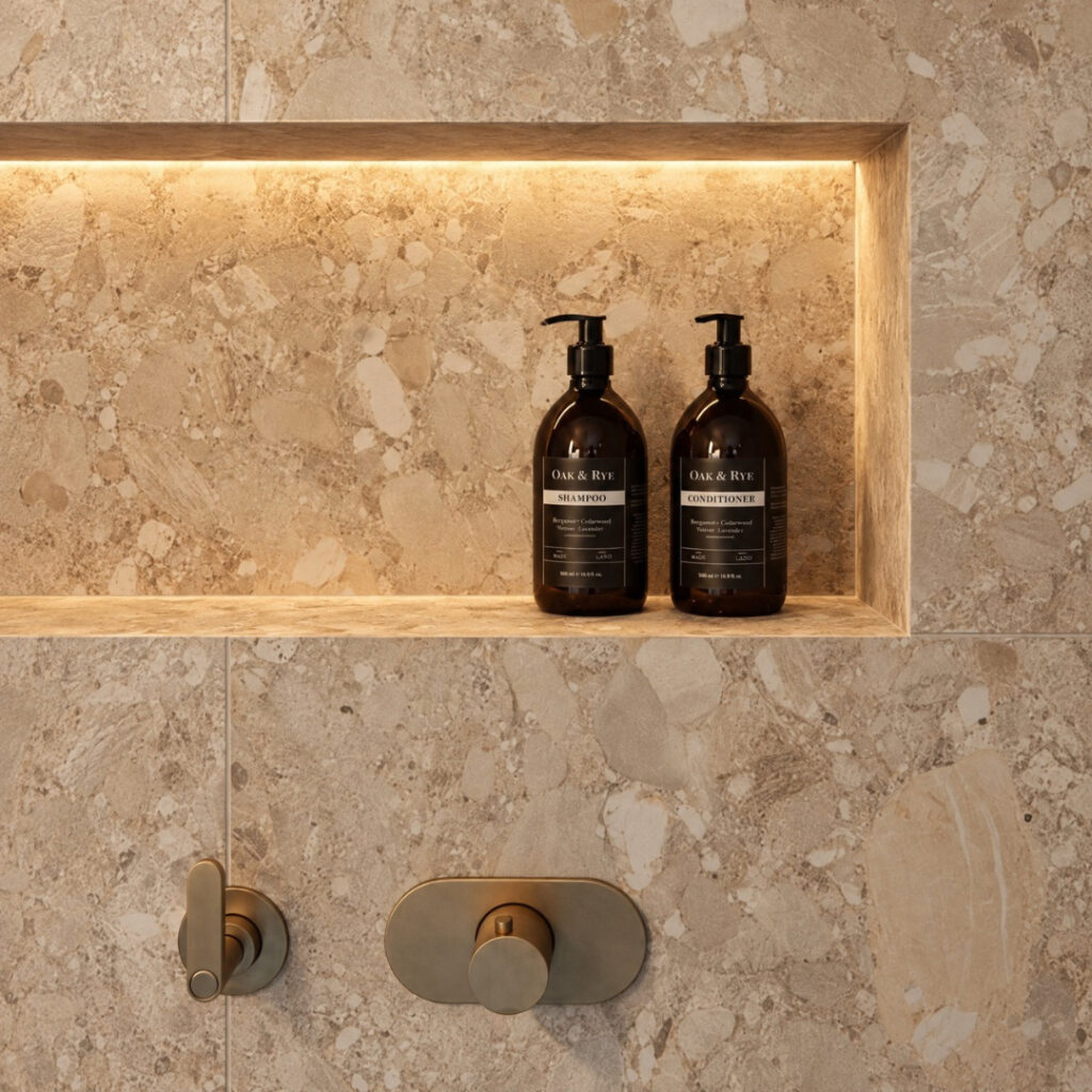 Elegant bathroom shelf with black shampoo and conditioner bottles in a modern shower.