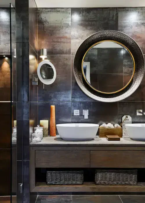 Elegant bathroom vanity featuring two round mirrors, vessel sinks, and contemporary decor for a luxu.