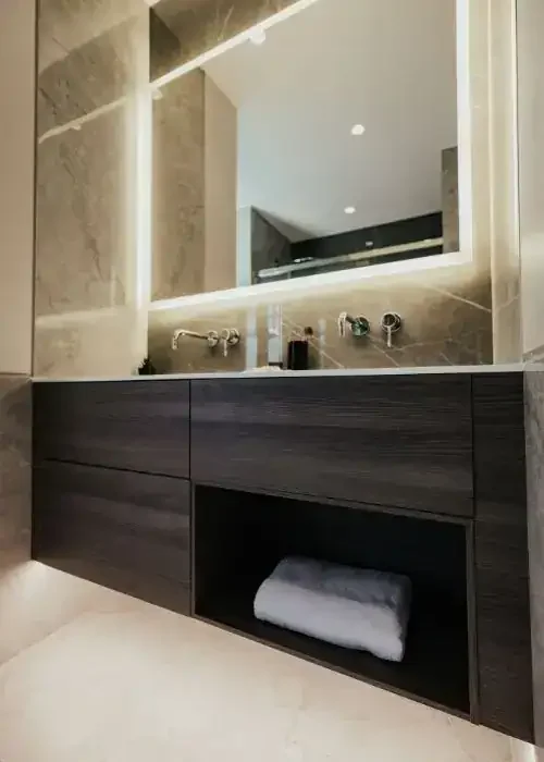 Bathroom vanity with illuminated mirror, modern storage cabinet, and sleek design for contemporary b.