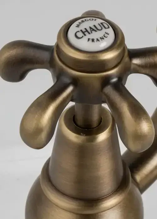 Vintage brass tap with "Chaud" label, ideal for classic bathroom decor.