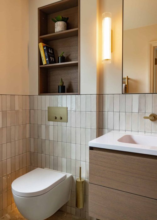 Modern bathroom with wall-mounted toilet and wooden shelving unit.