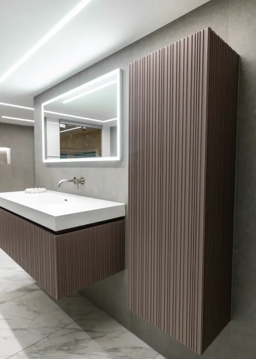 Modern guest bathroom with sleek vanity and vertical wooden storage cabinet.