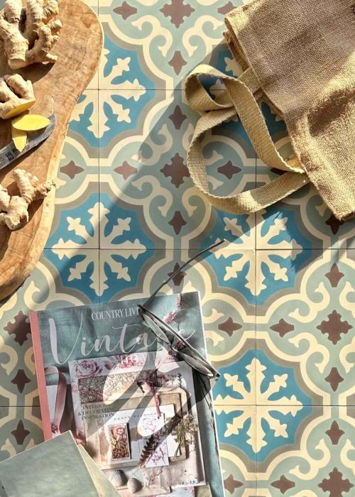 Luxury coloured bathroom tiles with intricate patterns and a tote bag on the floor.