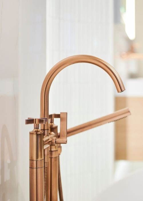 Close-up of a modern rose gold kitchen tap with a sleek design.