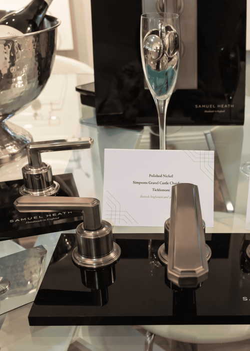 Elegant champagne flute with silver spoon and bathroom accessories display.