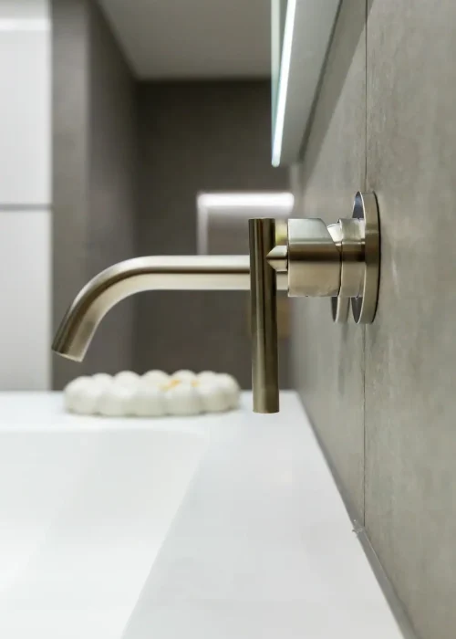 Modern bathroom sink with sleek wall-mounted faucet and minimalist design.