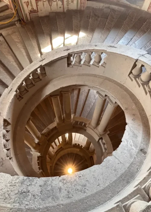Spiral staircase looking down through Palazzo Farnese in Italy, visited by Kallums Bathrooms