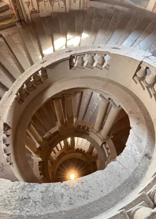 Spiral staircase looking down through Palazzo Farnese in Italy, visited by Kallums Bathrooms