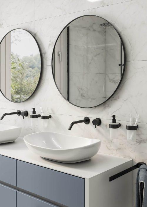 Modern bathroom features dual round mirrors, sleek faucets, and a double basin on a blue vanity. Marble walls enhance the elegant, minimalist design.